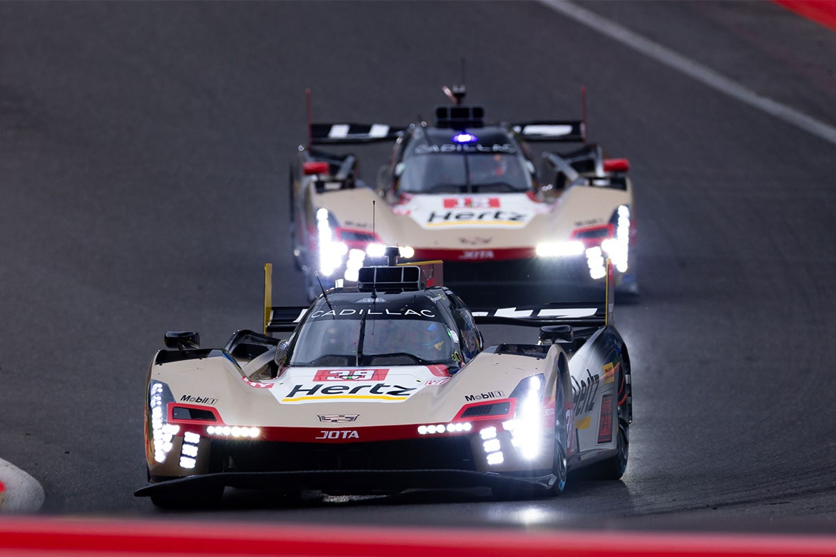 The No.38 Cadillac V-Series.R Racecar Followed by the No.12 Racecar on a Race Track