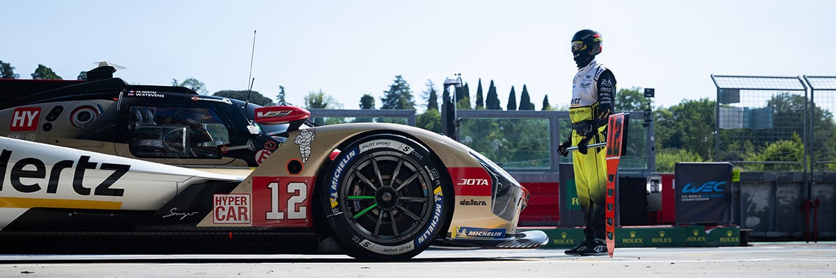 Side View a Cadillac Race Car Speeding Around the Race Track