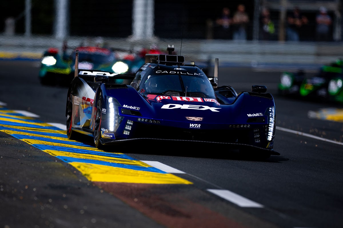The No.38 Cadillac V-Series.R Racecar Followed by the No.12 Racecar on a Race Track