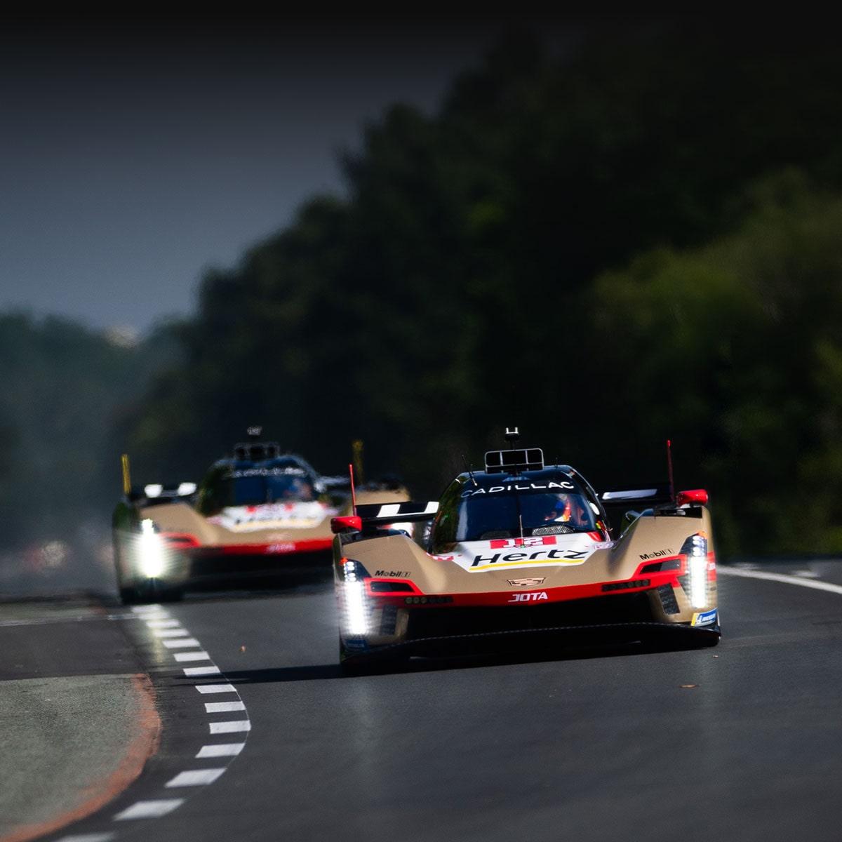 The No. 12, No. 101, and No. 38 Cadillac Racecars Lined Up in Front of a Large Group of Cadillac Racing Team Members Posing