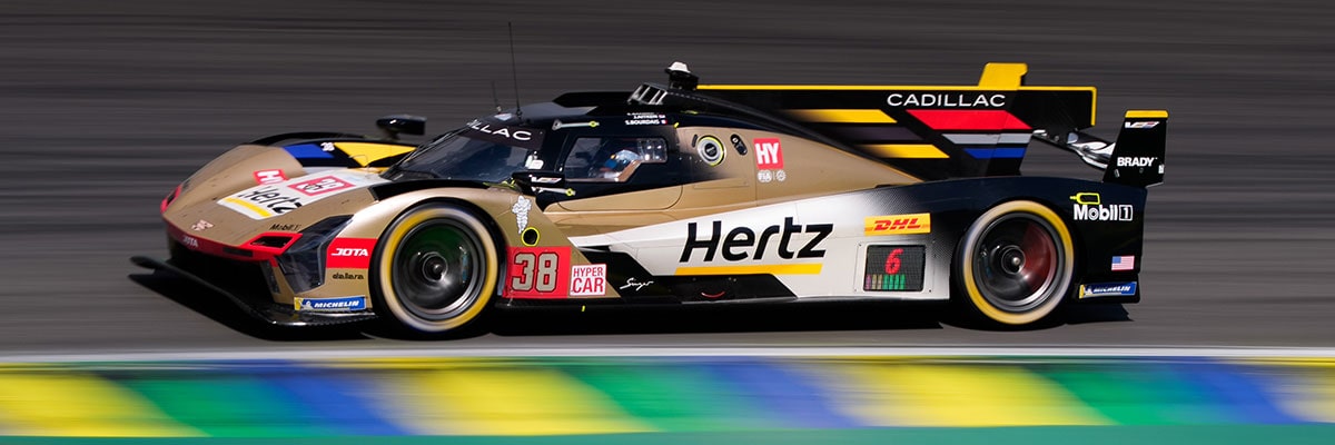 Profile View of a Cadillac Race Car Speeding By on a Racetrack