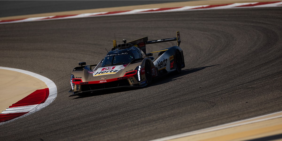 Bird's-eye View of the Cadillac V-Series.R Hypercar Race Cars Leading and Speeding Down a Race Track