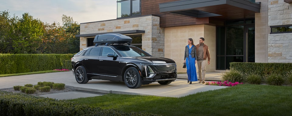 Couple getting into their Cadillac vehicle