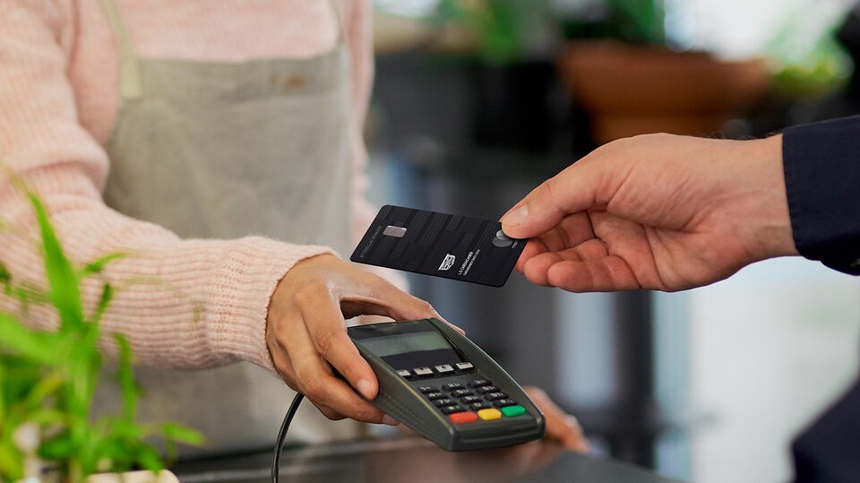 Man Using His My Cadillac Rewards Card at Coffee Shop to Earn Points