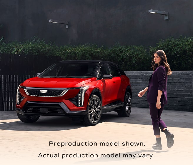 Woman in front of a cadillac vehicle