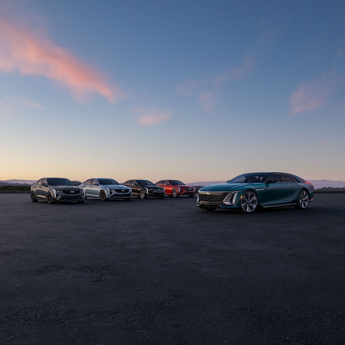 The Cadillac Sedan Line-up Parked in an Open Desert During Dusk