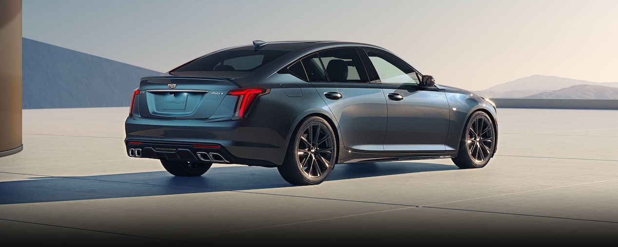 An Exterior Rear View of a Parked 2026 Cadillac CT5 Sport Sedan Outlooking the Blue Sky