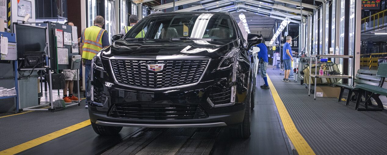 Cadillac XT6 on assembly line as people work around it