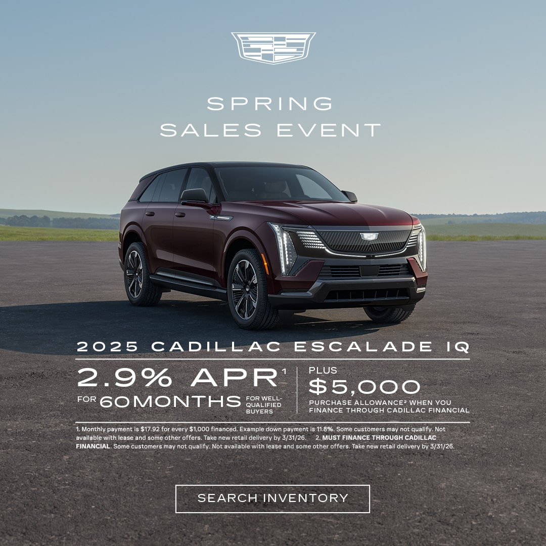 Three-quarter View of a 2026 Cadillac OPTIQ Parked Under a Beautiful Sky Next to a Current Offers Promotional Text