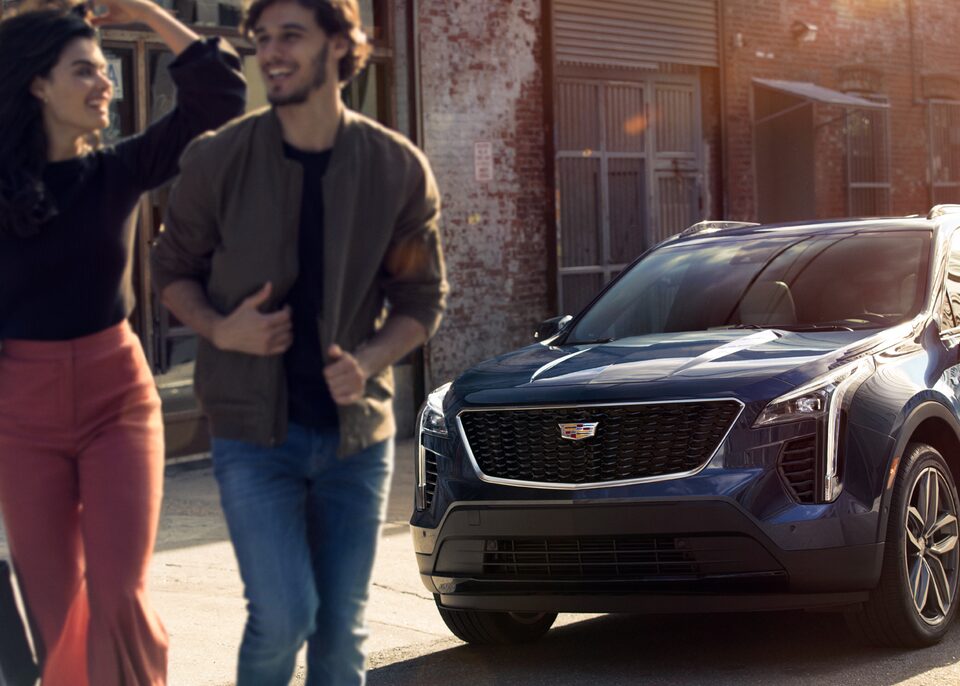 Cadillac Dealership Employee Discount Program: people walking from front view Cadillac SUV