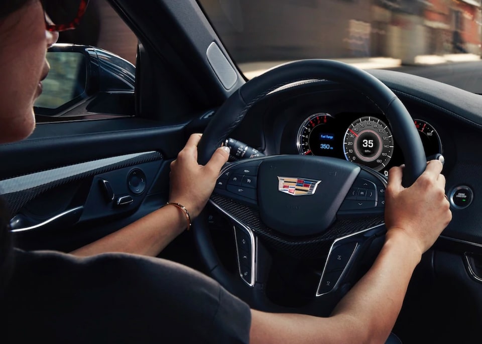 Cadillac First Responders Discount Program: A person hands on the Cadillac steering wheel