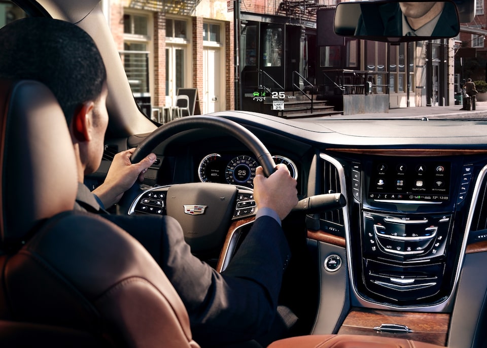 Cadillac Military Discount Program: Interior dashboard with a man driving