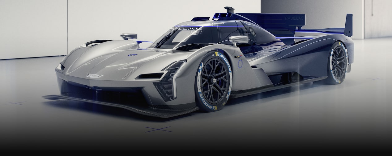 The Silver Cadillac V-ONE Concept Vehicle Positioned at a Front Three-Quarter Angle on a White Studio Floor With Blue Alignment Markers and an Oversized Rear Wing.