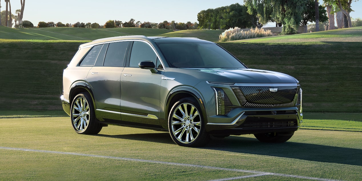 Three-quarters View of a 2026 Cadillac VISTIQ Parked on a Grassy Tennis Court
