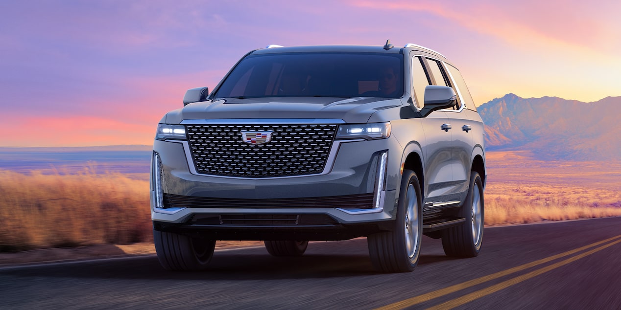 A Shot of the Silver Cadillac Escalade Driving On-Road