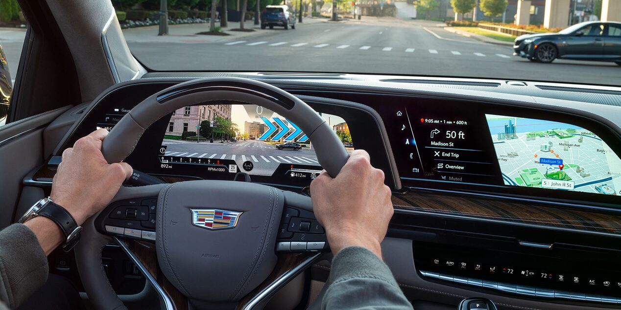 A Person with Their Hands on the Wheel of the Cadillac Escalade