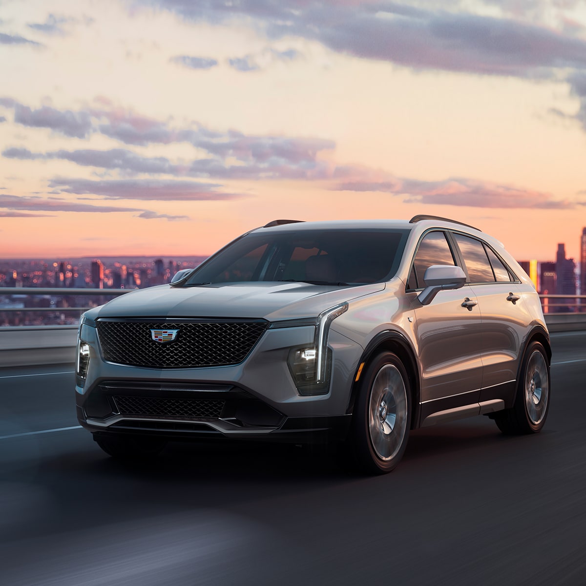 The XT4 Driving on an Overpass with the City in the Distance During Sunset