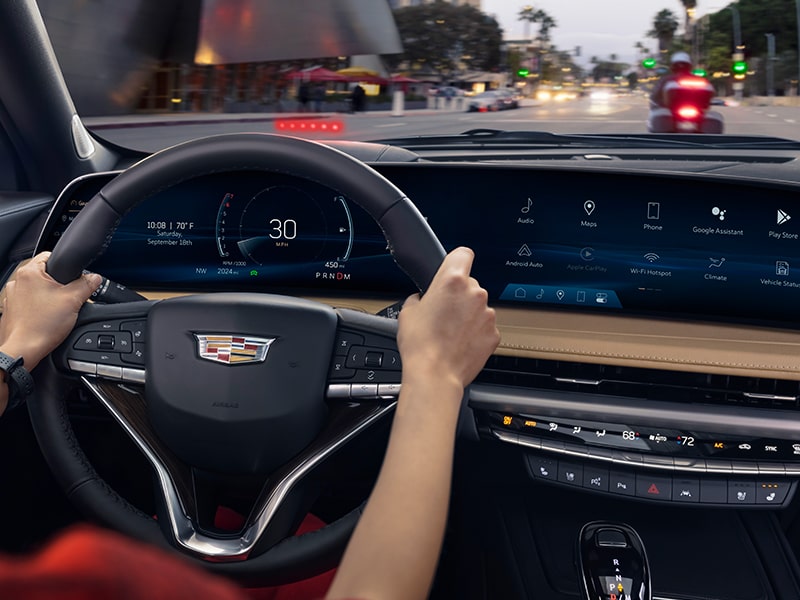The Rear View Camera Displays a Car while the Driver of a XT4 Reverses