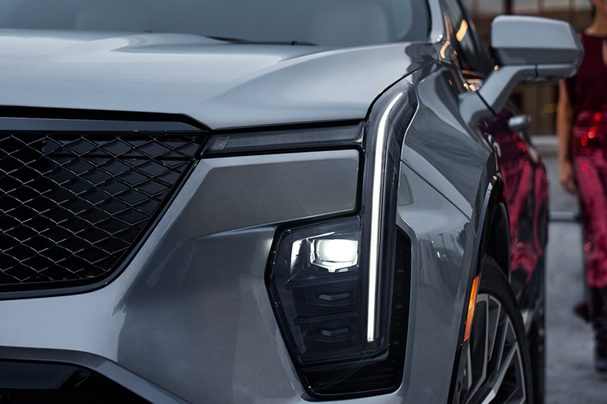 Woman In A Fancy Dress Approaches Her 2024 Cadillac XT4 On A Parking Structure