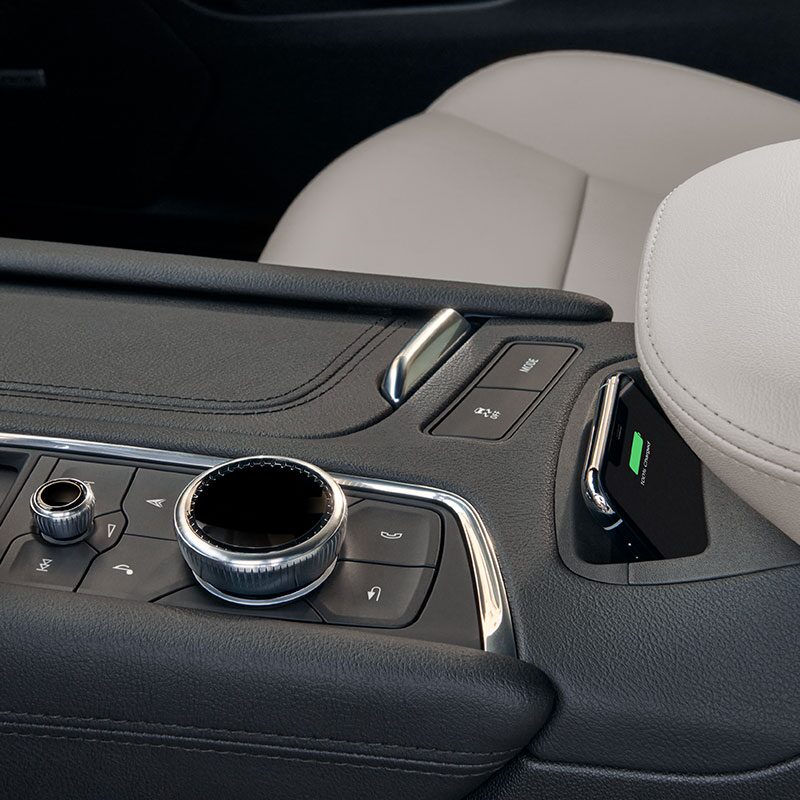 Driver Using the Wireless Phone Charger of the New Cadillac XT5