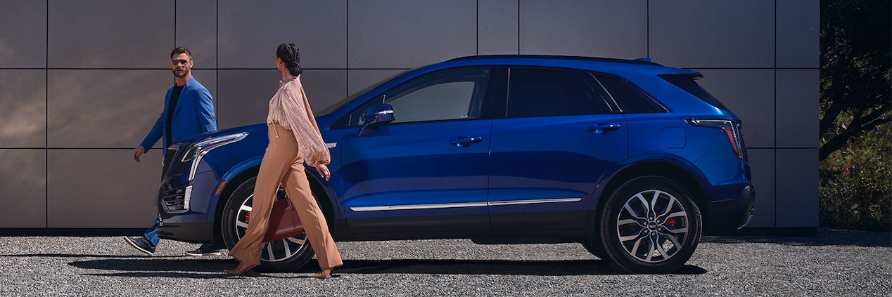 A Couple Walks Away From Their Parked 2024 Cadillac XT5