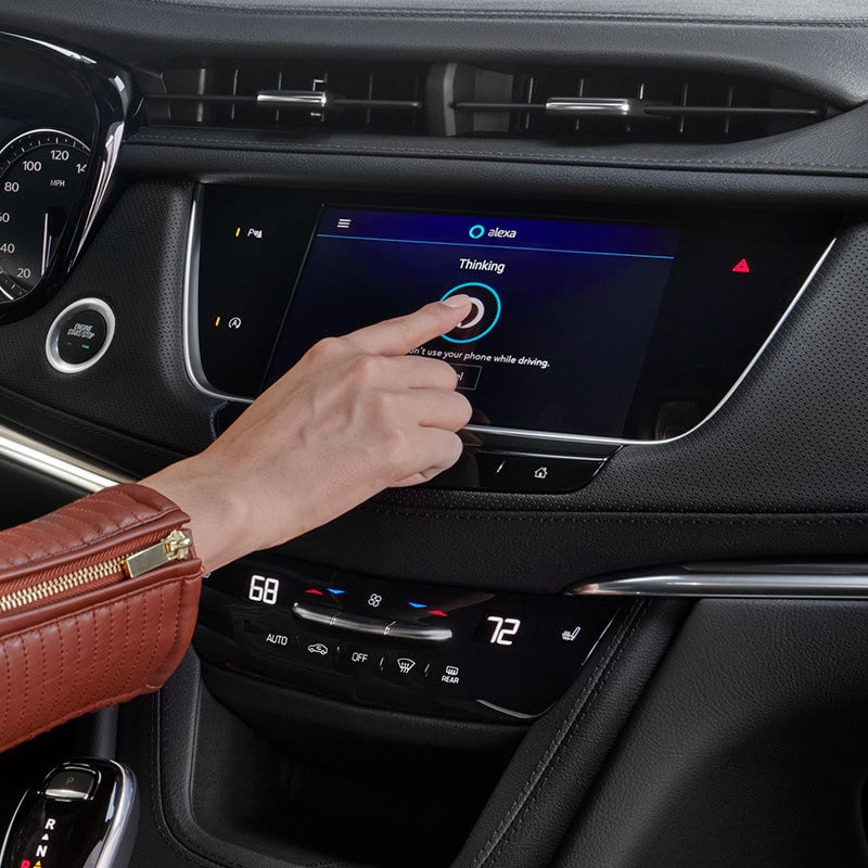 A Woman Activates the Built-In Amazon Alexa of the Cadillac XT5