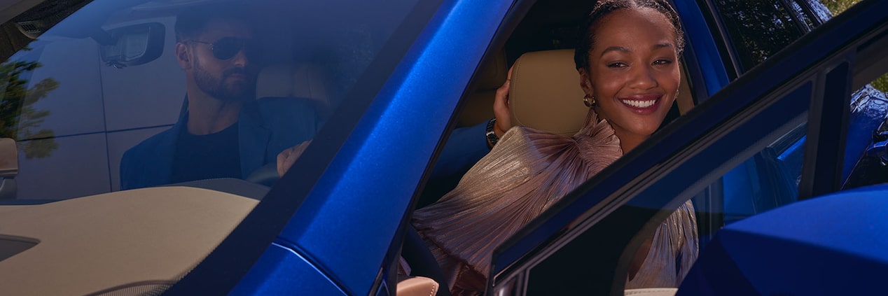 A Woman Activates the Built-In Amazon Alexa of the Cadillac XT5