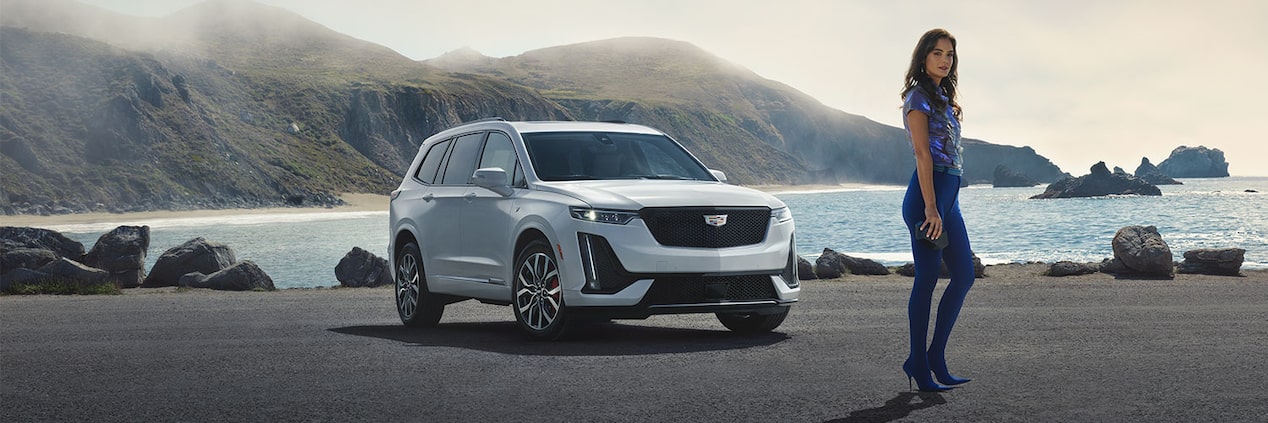 The Cadillac XT6 Driving on an Open Road with an Incredible View of Mountains