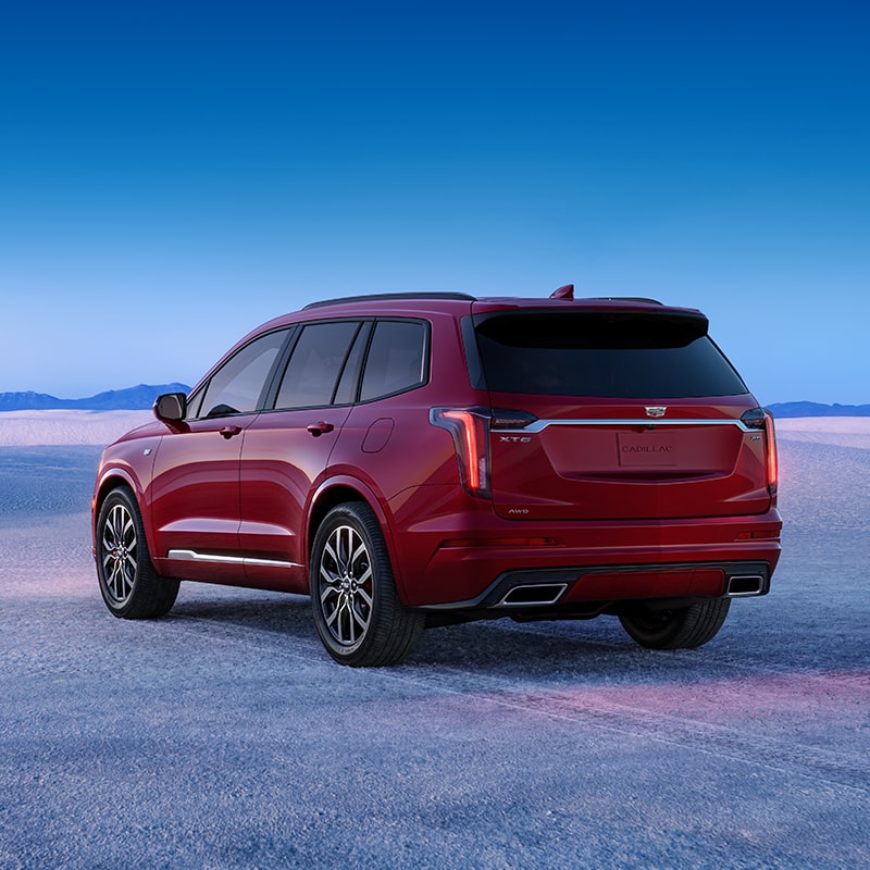 The Cadillac XT6 Driving on an Open Road with an Incredible View of Mountains