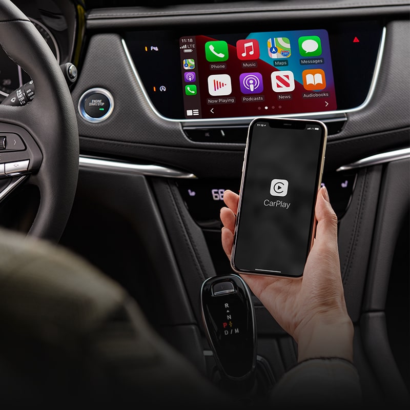 Driver Syncing Up Their Phone to Apple Car Play in The New Cadillac XT6