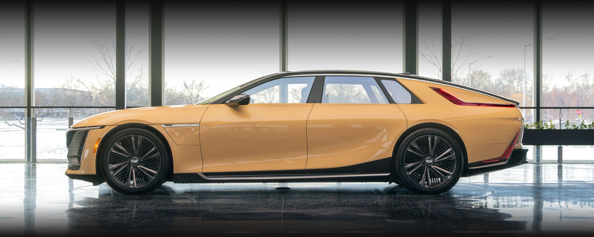 The Cadillac CELESTIQ Car's Rear Interior Features Cream-Colored Seats with Dual Entertainment Screens.