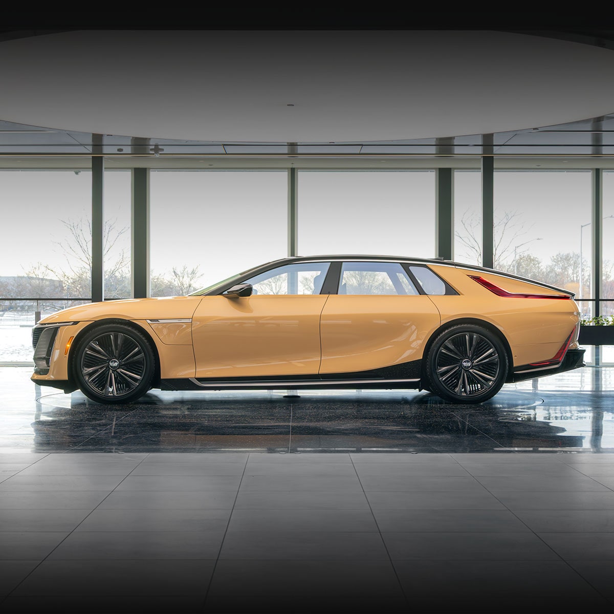 A Red Cadillac CELESTIQ Car is Parked Indoors, Showcasing its Sleek Side Profile.