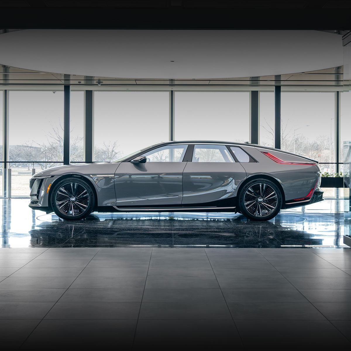 A Dark Gray Cadillac CELESTIQ Is Parked in Front of a Golden Textured Wall, with the Text Sea Wolf Visible.test