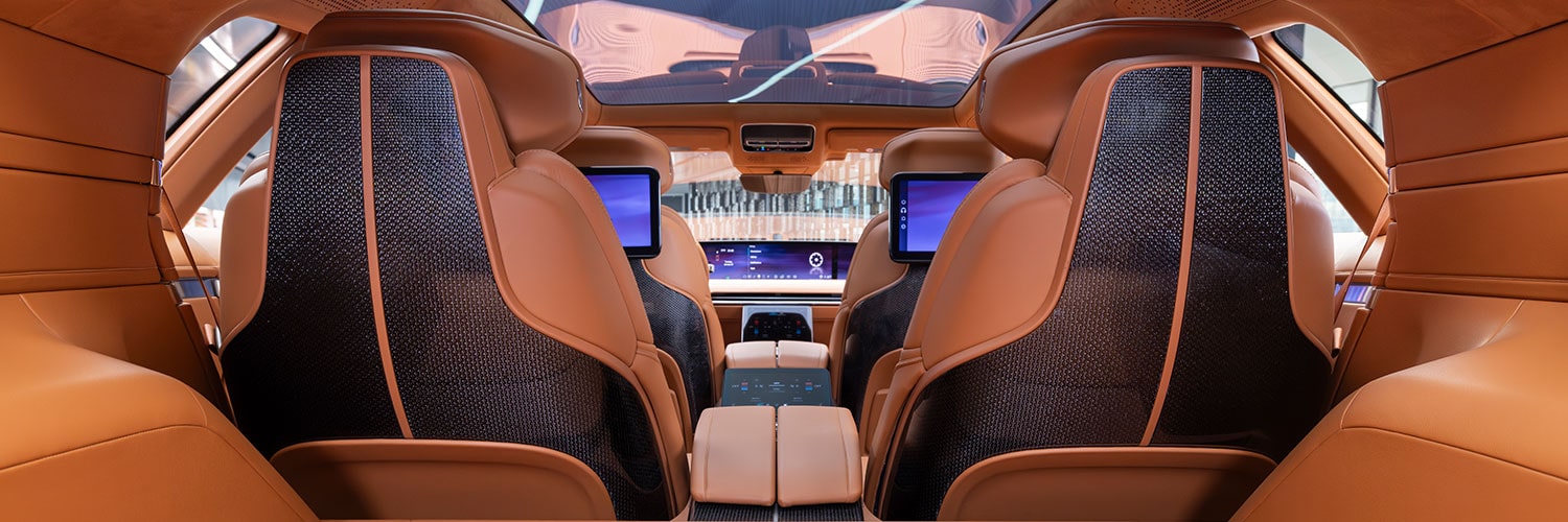 The Cadillac CELESTIQ Car's Rear Interior Features Cream-Colored Seats with Dual Entertainment Screens.