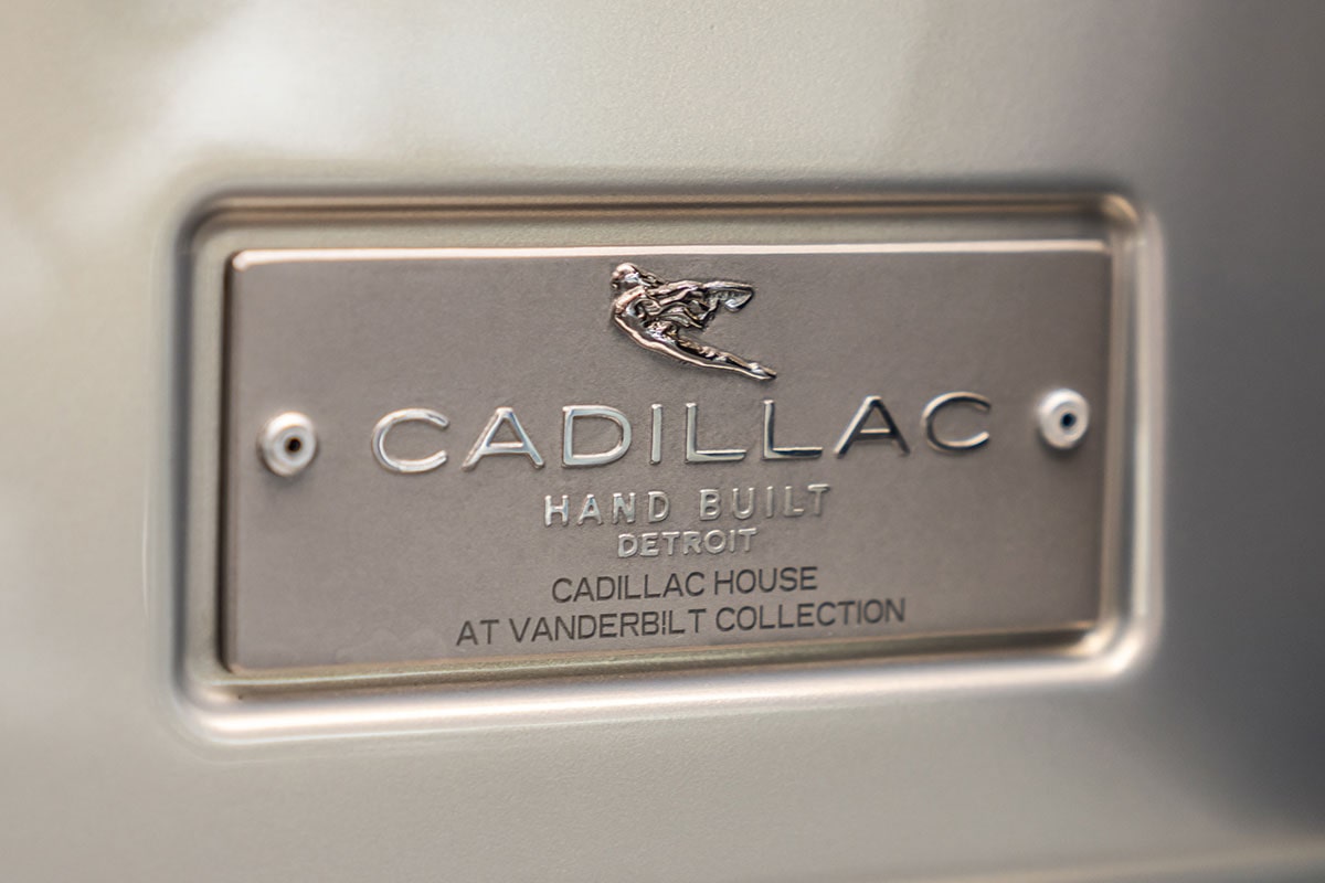 A Brushed Metal Plaque on the Car's Exterior Reads 'Cadillac Hand Built Detroit Cadillac House at Vanderbilt Collection'.