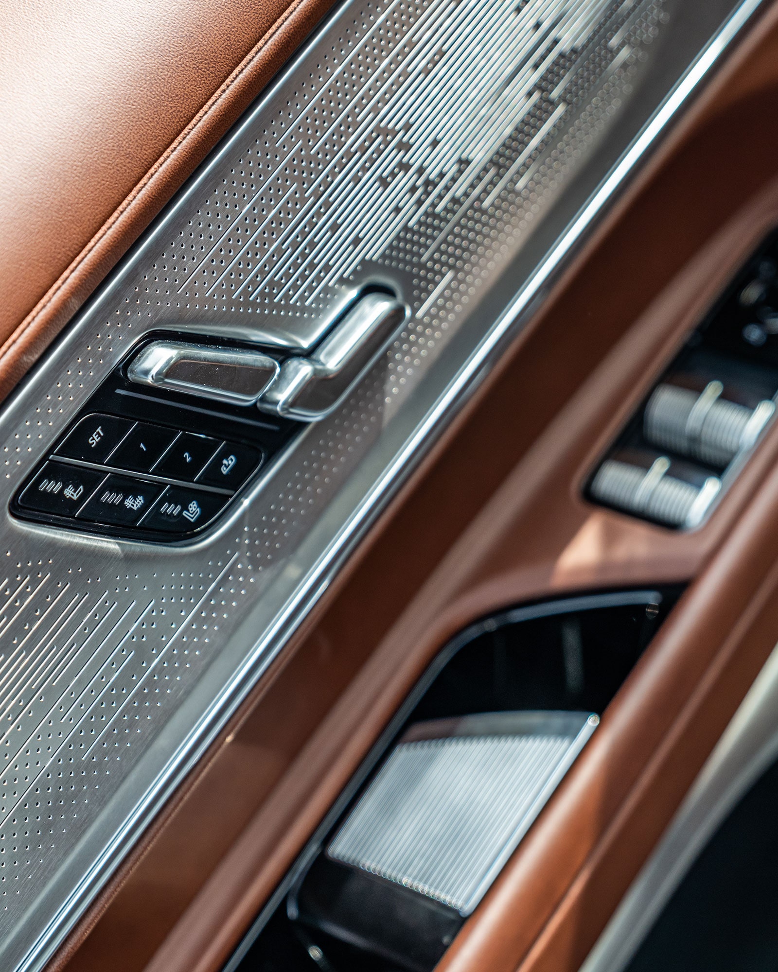 A Close-Up of the Cadillac CELESTIQ Door Panel, Showing Intricate Metal Detailing and Seat Adjustment Controls.