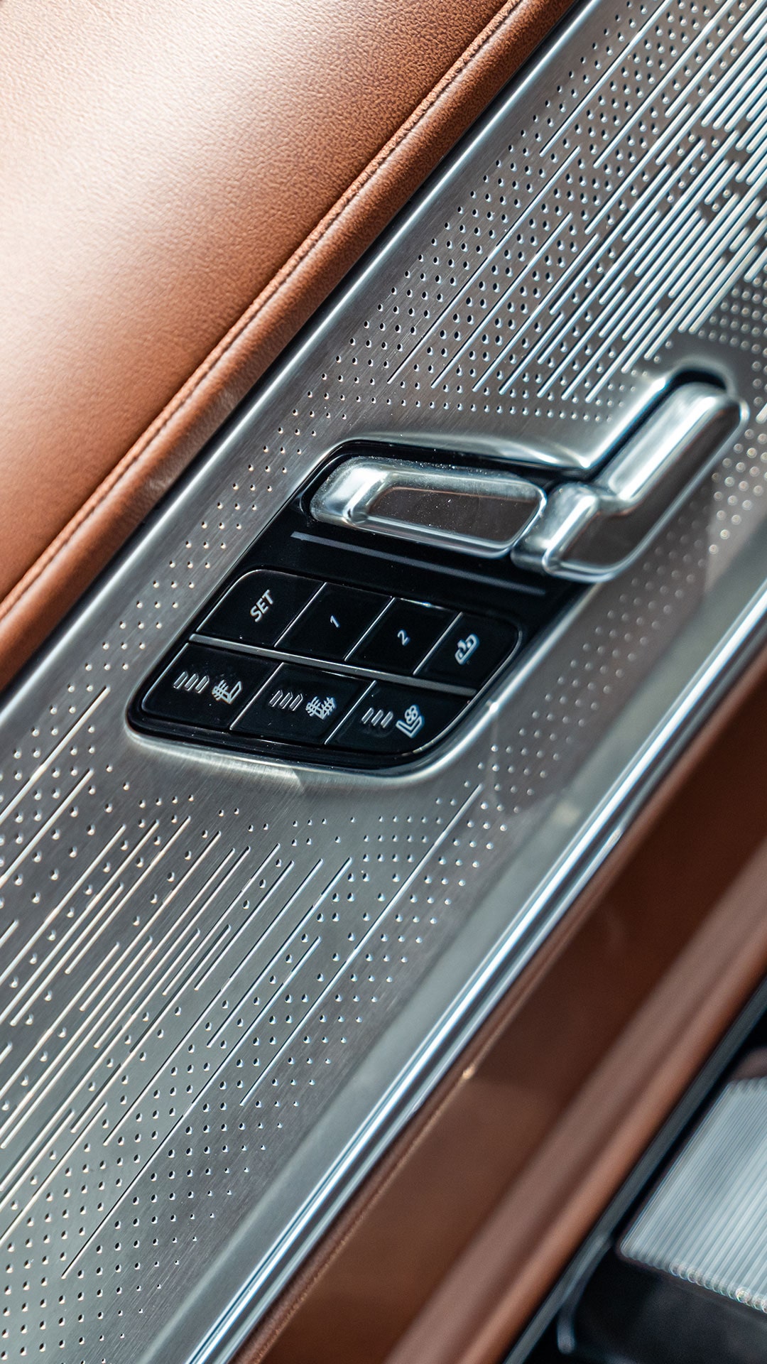 A Close-Up of the Cadillac CELESTIQ Door Panel, Featuring Intricate Silver Detailing and Seat Adjustment Buttons.