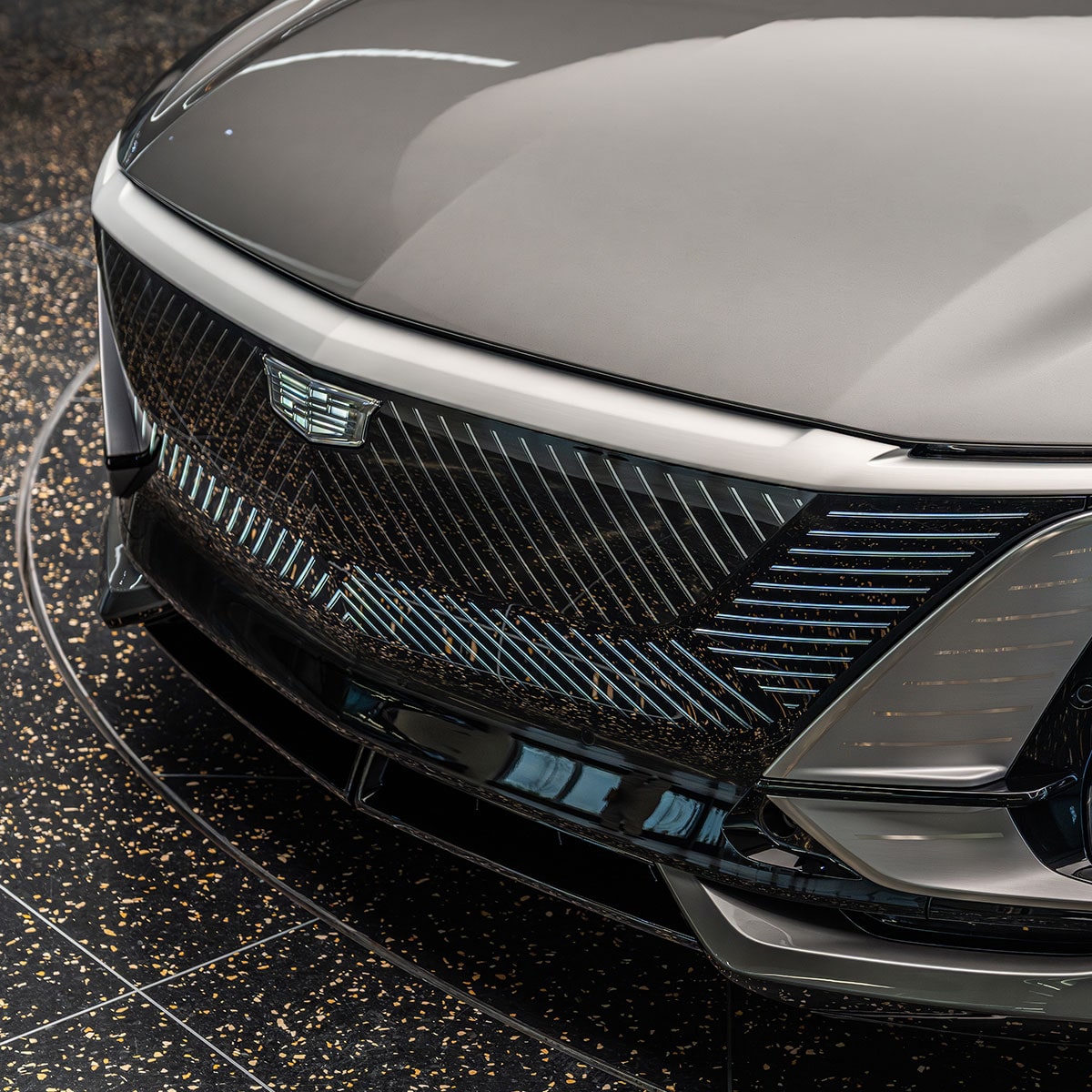 A Close-up View of the Red Leather Steering Wheel of the Cadillac CELESTIQ, with the Cadillac Logo and Digital Dashboard Visible.