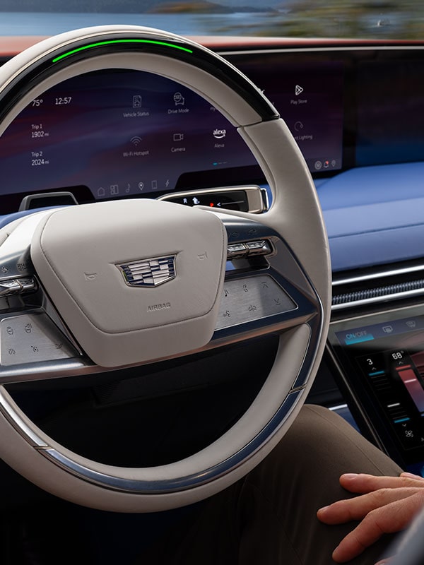 A Cadillac CELESTIQ Steering Wheel Positioned in Front of a Wide Digital Dashboard Display Inside the Vehicle