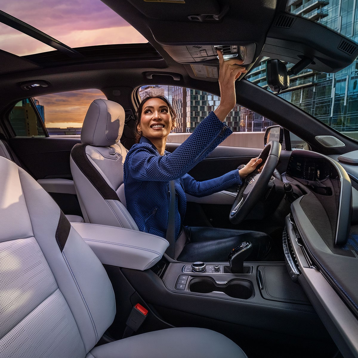 A Woman Activates the Dual Glass Power Sunroof of a 2025 Cadillac XT4 in the City