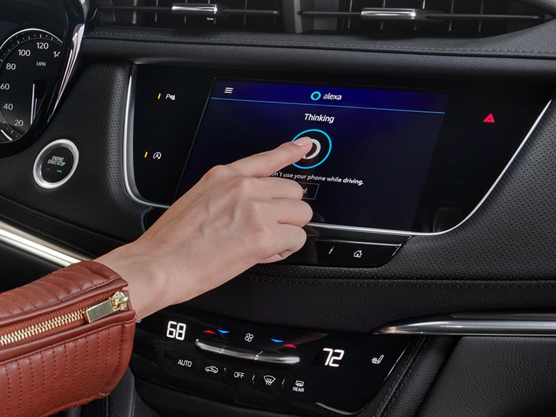 A Woman Activates the Built-In Amazon Alexa on the Cadillac XT5 Infotainment System