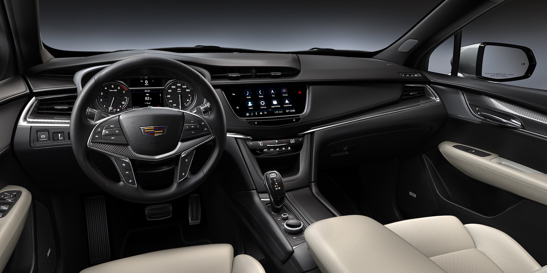 Cockpit view of the 2025 Cadillac XT5 beige with black carbon fiber accented interior