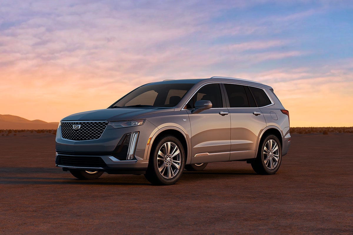 Side View of a Silver Cadillac XT6 in a Desert under an Evening Sky
