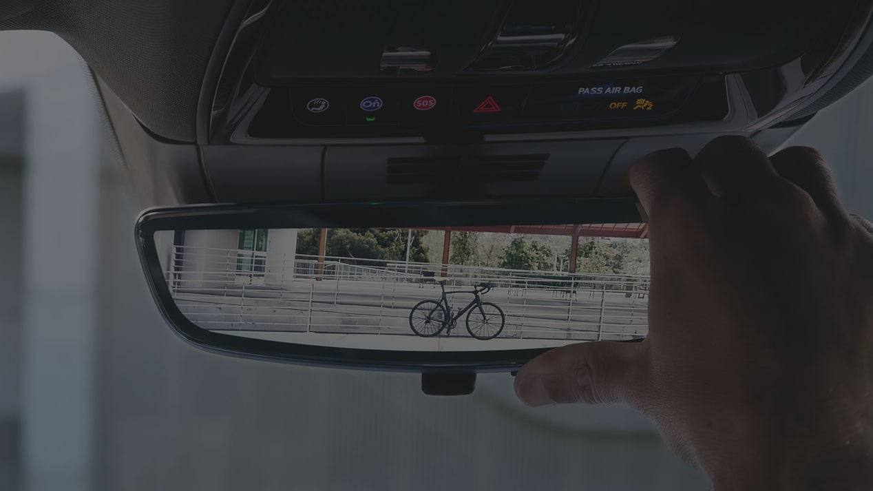 A Close Up of The Cadillac LYRIQ's Rear View Mirror Being Adjusted