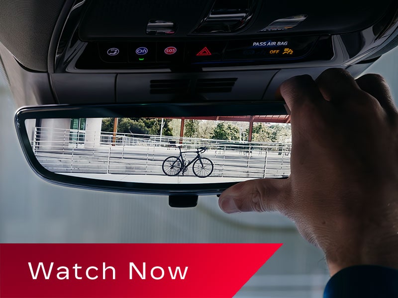 A Close Up of The Cadillac LYRIQ's Rear View Mirror Being Adjusted