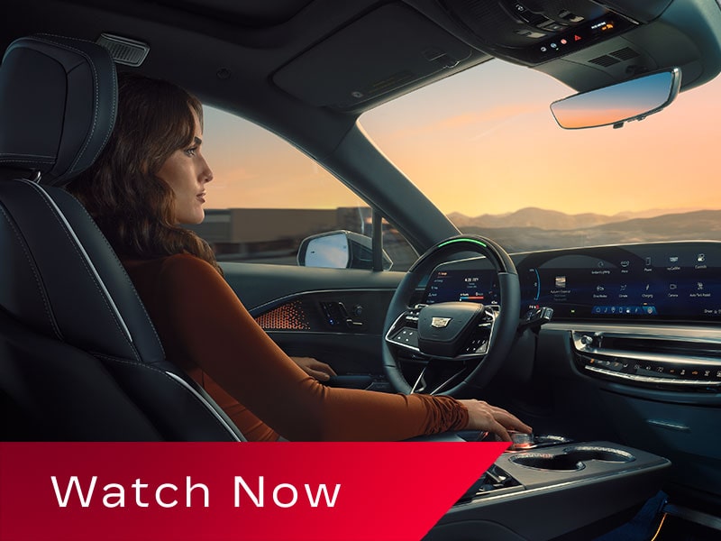 Passenger Seat View of a Woman Driving a Cadillac LYRIQ Hands-free Utilizing the Super Cruise Feature