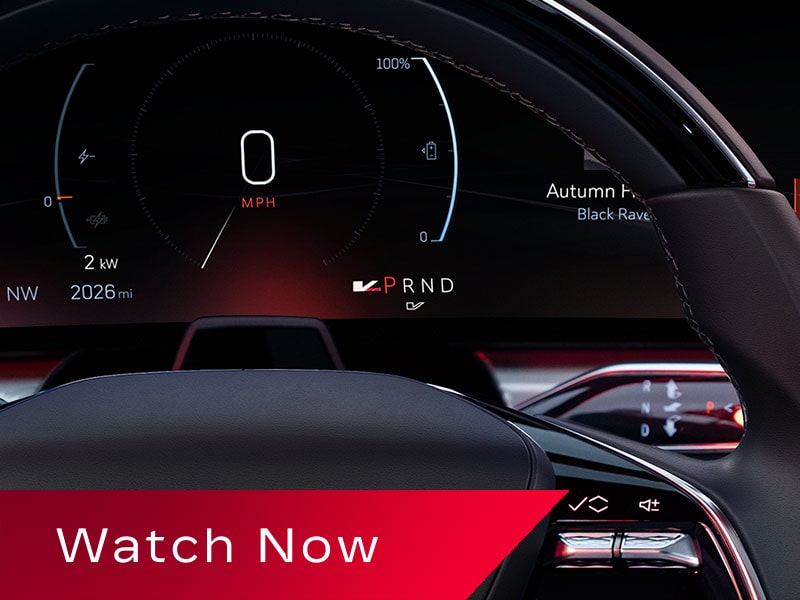 A Digital Cadillac LYRIQ Driver Display Showing Torque Output, Speed, And PRND Gear Indicators Partially Framed By the Steering Wheel.