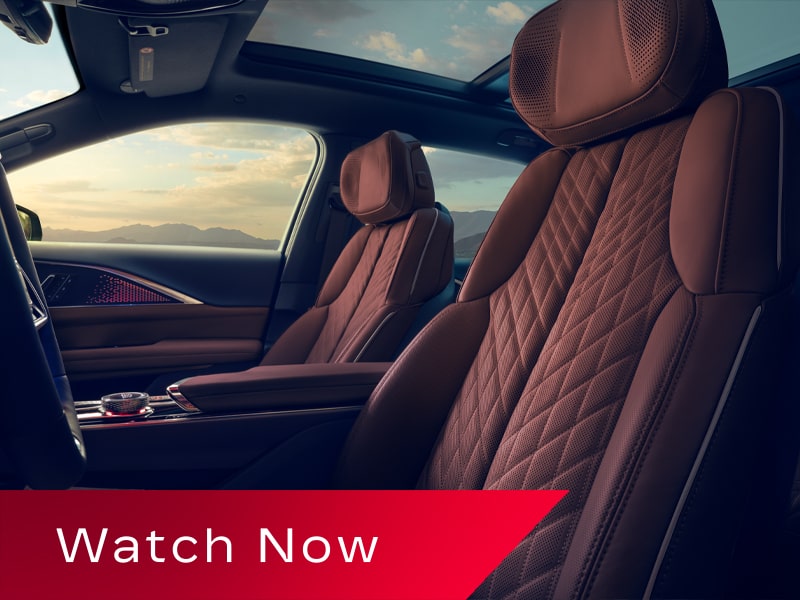 Video Thumbnail Showing the Front Seats of a 2027 Cadillac LYRIQ With Quilted Leather Upholstery and a Panoramic Glass Roof.