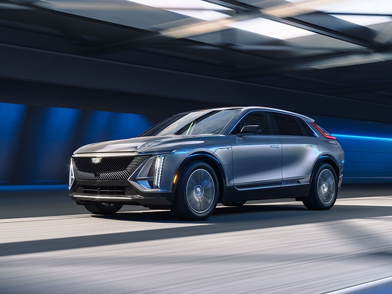 Side Profile of a Silver 2025 Cadillac LYRIQ Speeding Down the Road