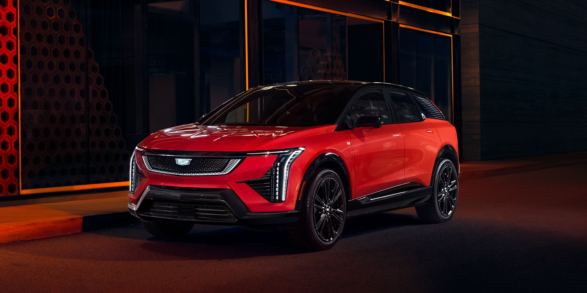 2025 Cadillac OPTIQ in red parked at night